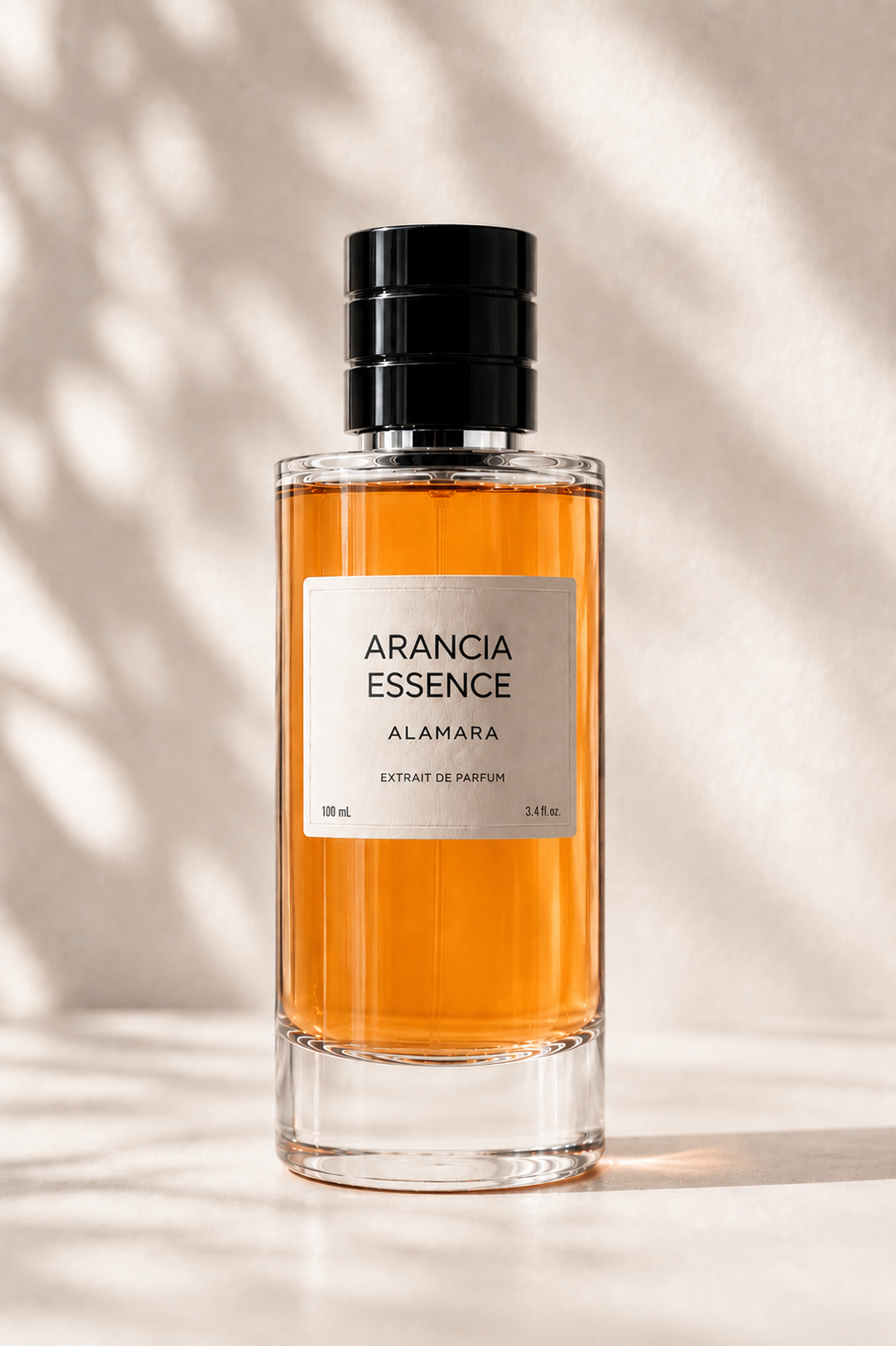 Perfume bottle labeled 'Arancia Essence' by Alamara on a neutral background