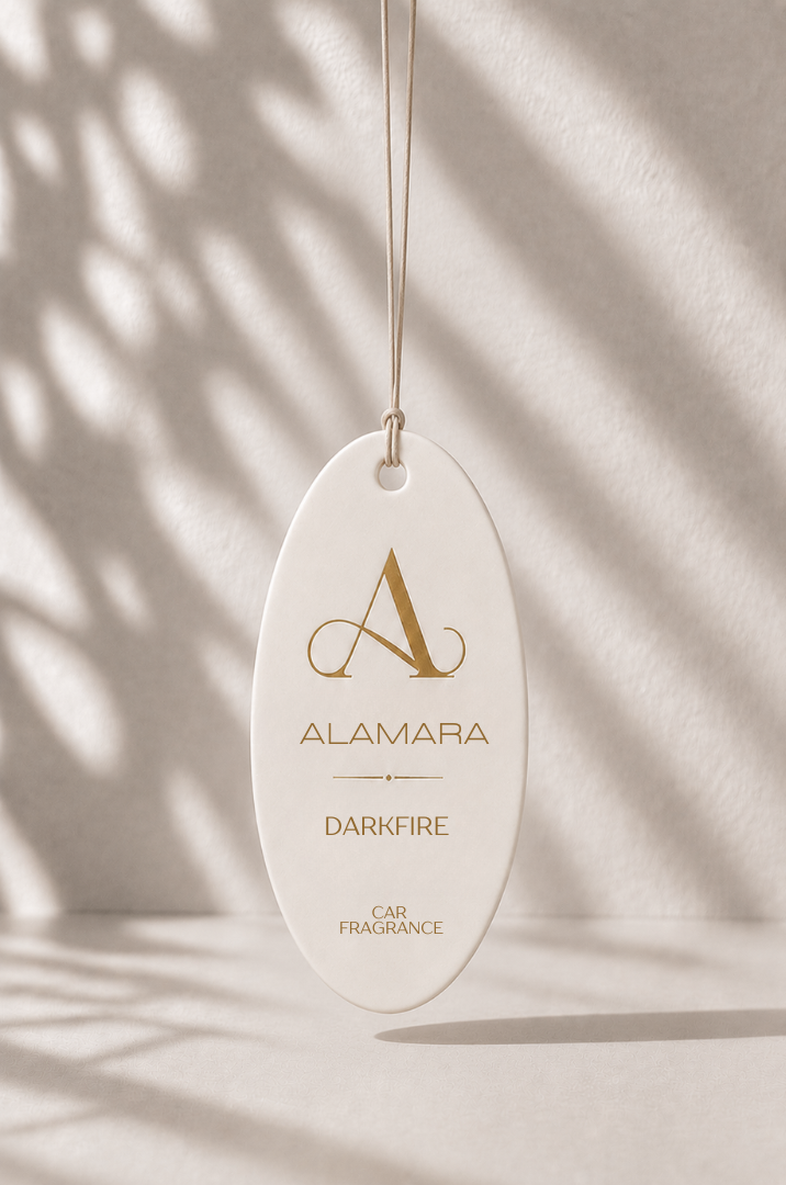 Alamara car fragrance hanging against a neutral background with shadows.