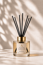 Reed diffuser with black sticks on a beige background