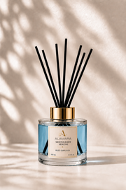 Reed diffuser with black sticks on a beige background