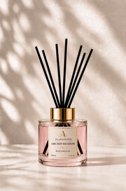Reed diffuser with black sticks on a light background
