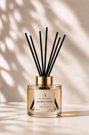 Reed diffuser with black sticks on a beige background